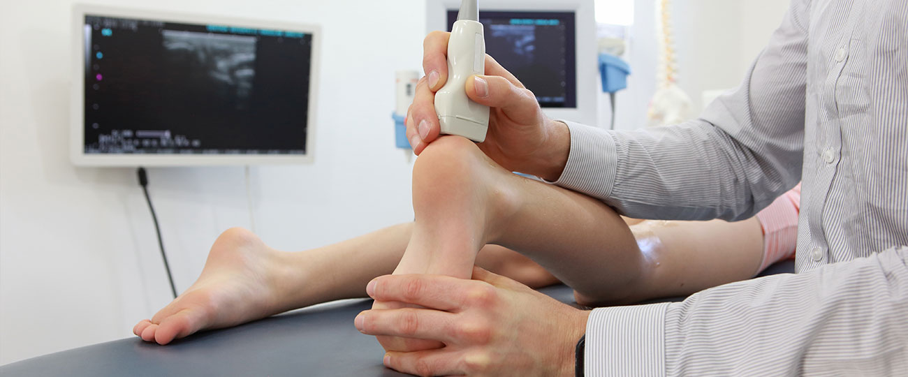 Medical Billing Experts in New York. Podiatry billing services. Podiatrist examining a foot.